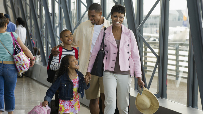 A happy family walking at the airport