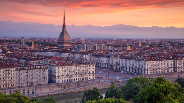 Turin's skyline featuring the prominent Mole Antonelliana set against a pink sky