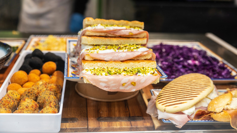 View of sandwiches, croquettes and fried snacks on a market counter