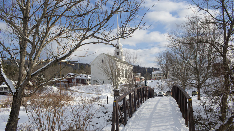 Stowe, Vermont, in winter with a bridge and a church surrounded by snowy ground