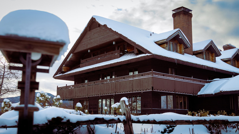Exterior of the wooden Trapp Family Lodge covered in snow