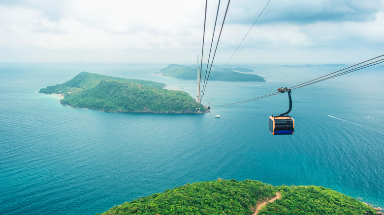 Cable car cabin gliding over turquoise sea and green tropical island. Longest Hon Thom cable car ride in the world on Phu Quoc island, Vietnam.
