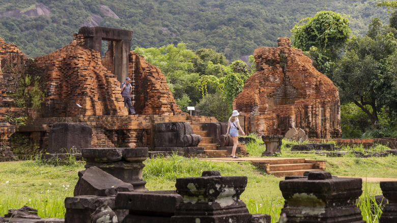 Tourists walk through My Son, a UNESCO site in Vietnam
