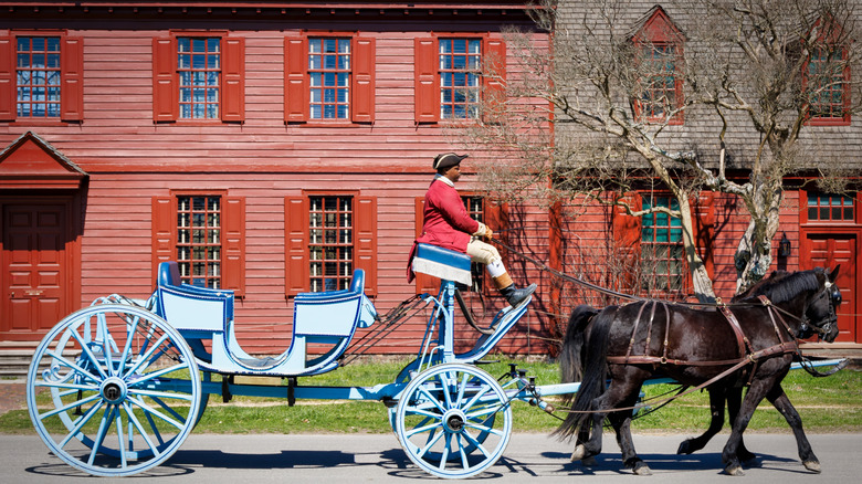 A horse-drawn carriage rolls through Colonial Williamsburg