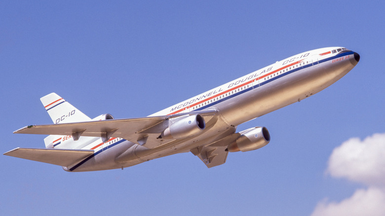 A McDonnell-Douglas DC-10 commercial plane in the sky on a clear day.