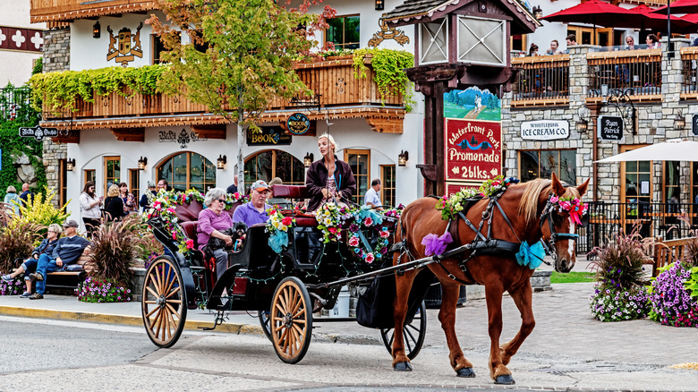 An older couple rides in a horse-drawn carriage in Leavenworth, Washinton