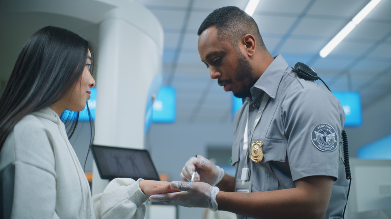 Passenger getting a hand swab at the airport
