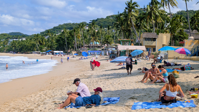 Tourists relaxing on the beach in Saylita, Mexico.