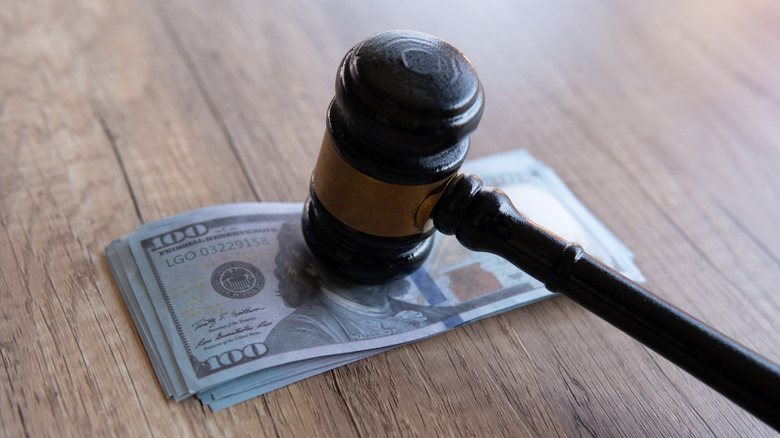 Close-up image of a gavel and money.