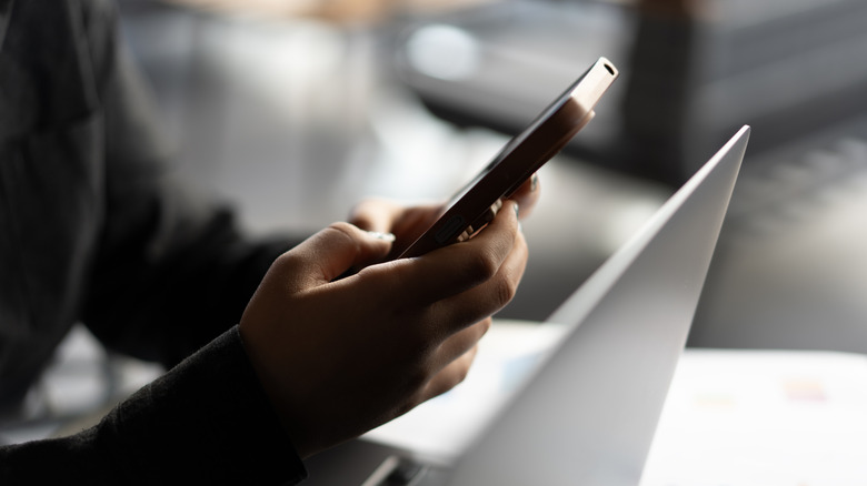 Close-up of young woman hand using smartphone