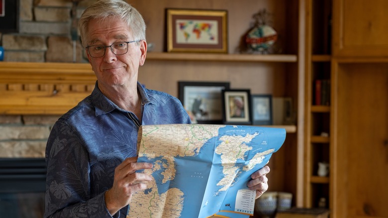 Rick Steves holding up a paper map