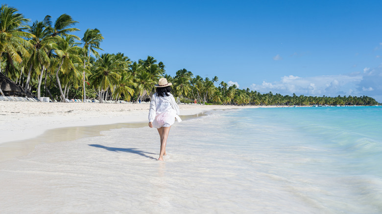 Woman walking on an empty beach in the Dominican Republic, Saona Island