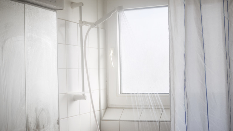 The silhouette of a man behind a shower curtain