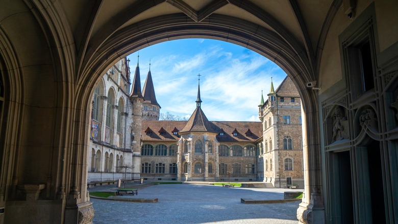 Archway leading to the ornate facade of the Swiss National Museum in Zurich