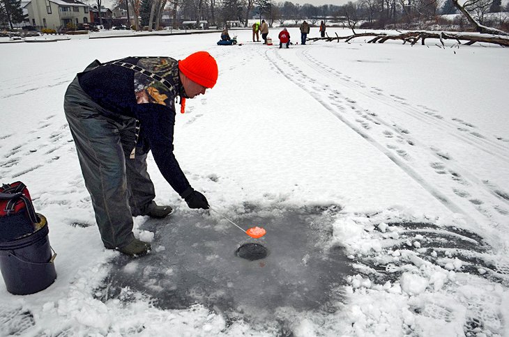 Clearing ice from the fishing hole on Mosquito Lake