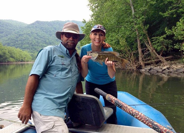 Anietra and expert guide Sean Wishart landing a smallmouth bass on the New River