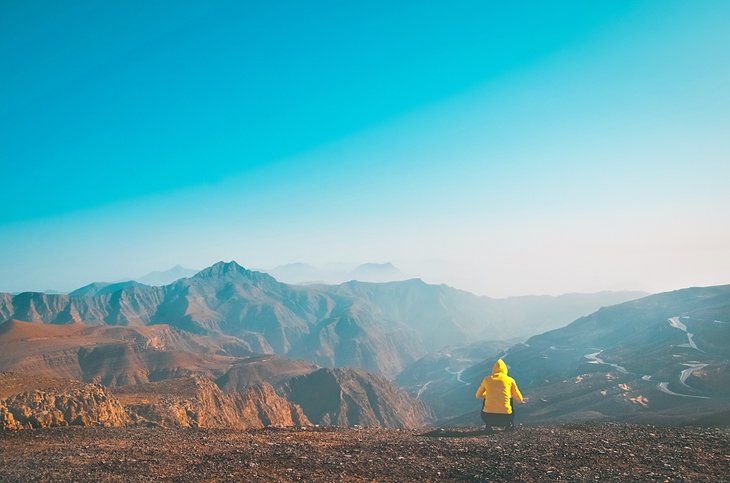 Hiker enjoying the view from Jebel Jais