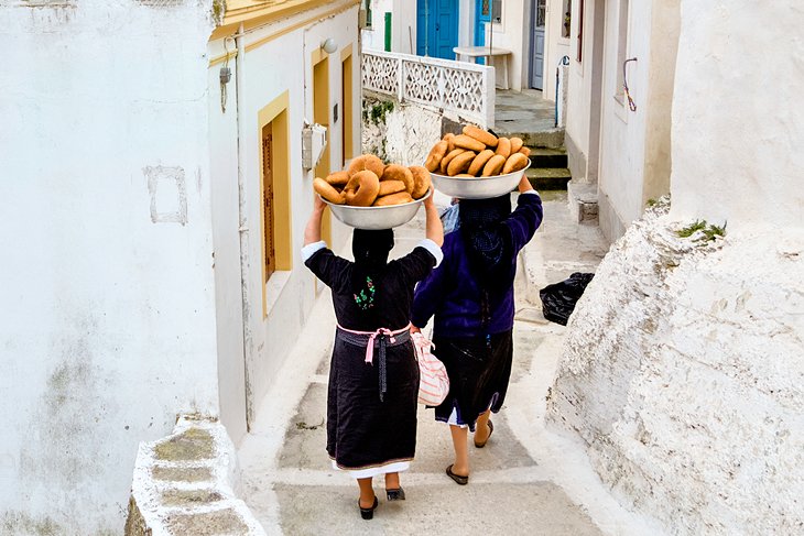 Women carrying bread from a community oven in Olympos, Kárpathos Island