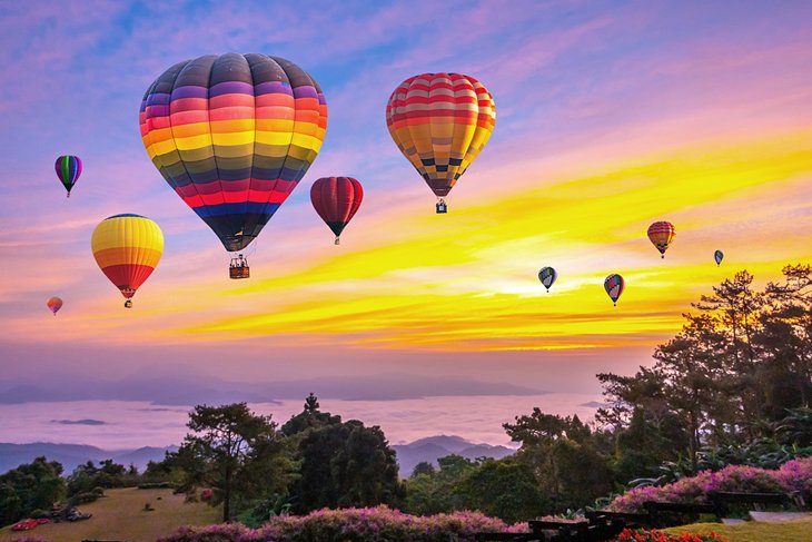 Hot air balloons over the mountains in Chiang Mai at sunrise