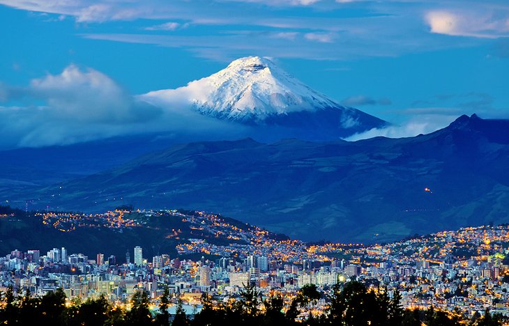 Quito at sunrise with the Cotopaxi volcano in the distance