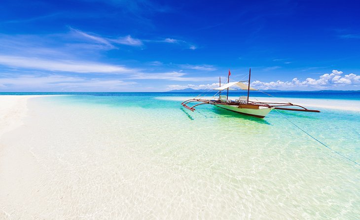 Traditional boat and crystal-clear water in the Philippines