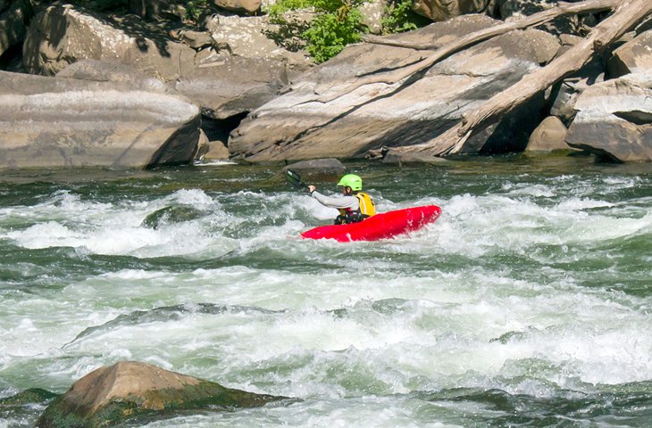 A kayaker tackling rapids in the New River Gorge