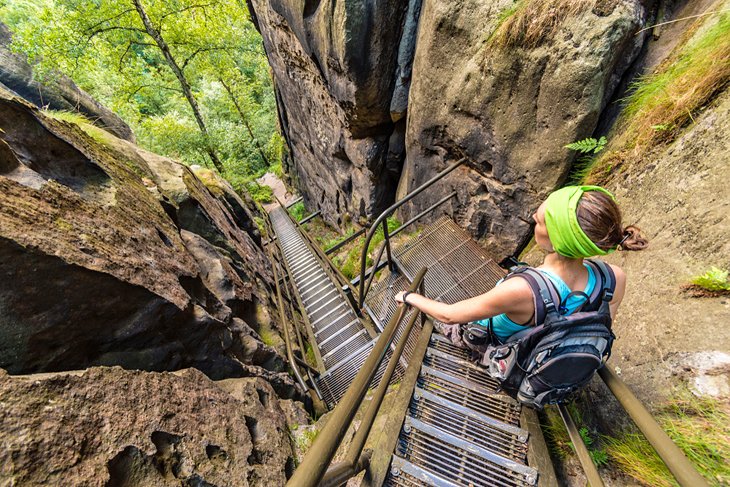 Hiker on steep stairs in the Bohemian Switzerland National Park