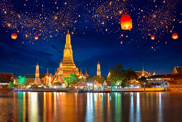 Paper lanterns floating above Wat Arun