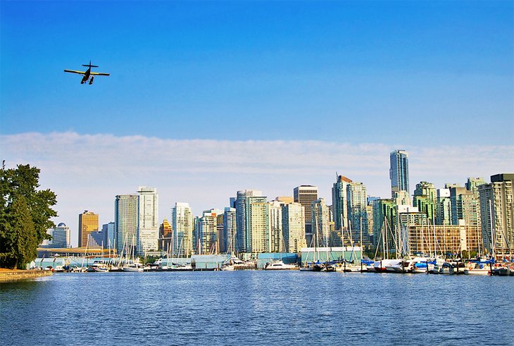 Seaplane flying over the Vancouver skyline