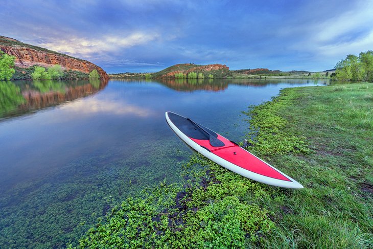 Paddleboard on the shore of Horsetooth Reservoir at dusk