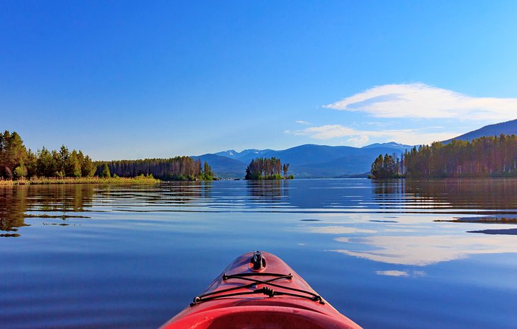 A kayaker on the calm waters of Shadow Mountain Lake