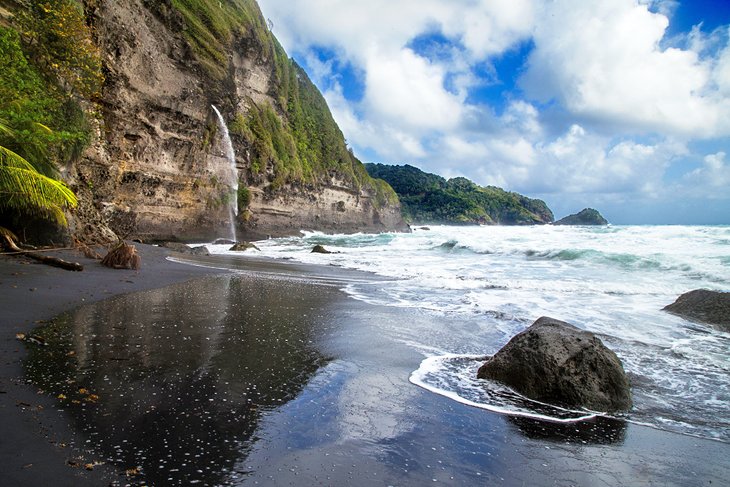 Black-sand beach and waterfall at Wavine Cyrique