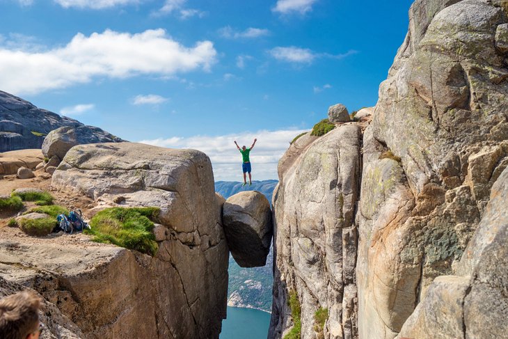 Man jumping on the Kjeragbolten