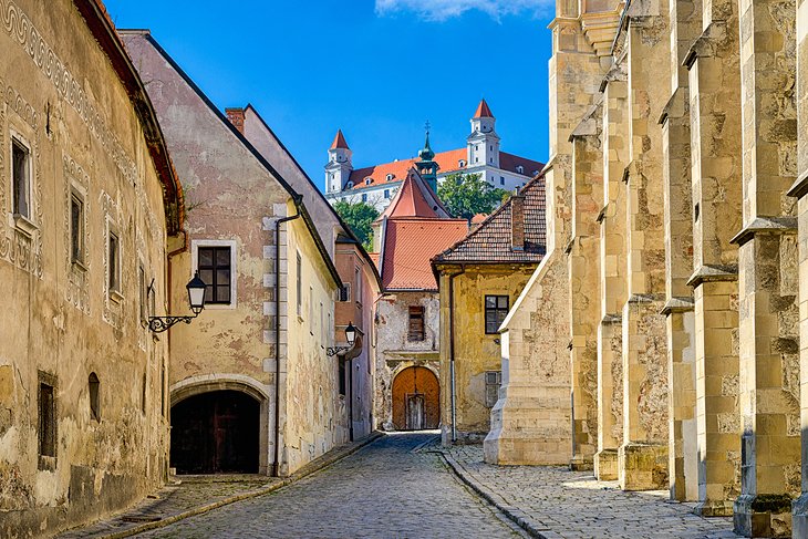 Street in Old Town Bratislava with Bratislava Castle in the distance