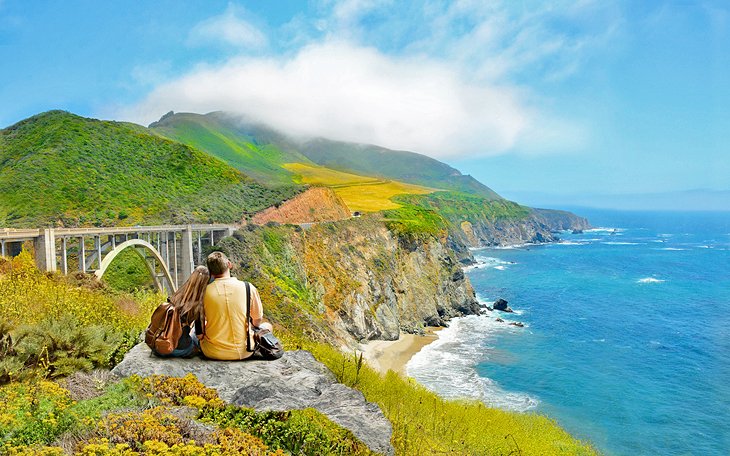 Couple enjoying the view of the Bixby Bridge and the Big Sur coastline