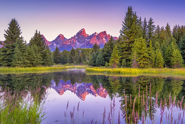 Teton mountains reflected at sunrise in the Snake River, Jackson, Wyoming