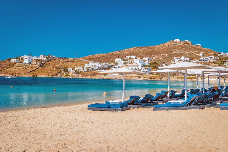 Lounge chairs and umbrellas on Ornos Beach