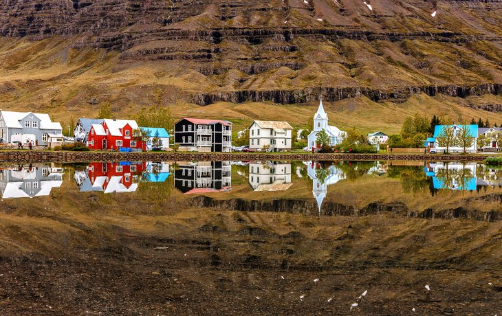 The town of Seydisfjordur reflected in Fjardara Lake
