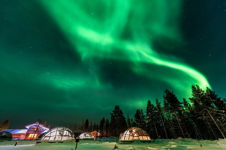 Northern lights above igloo houses in Lapland, Finland