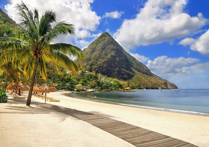 Palm-lined beach with a view of one of the Pitons on St. Lucia
