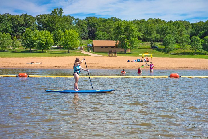 Paddleboarder at the beach on Mark Twain Lake