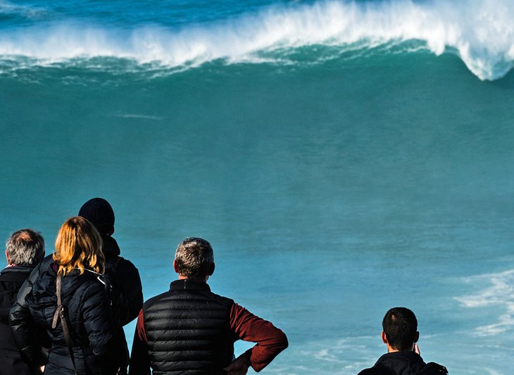 Spectators watching big waves in Nazaré