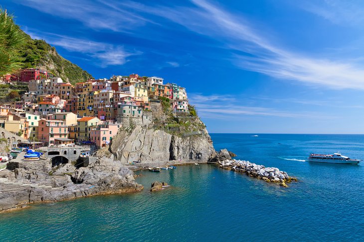 Ferry gliding by the village of Manarola, Cinque Terre