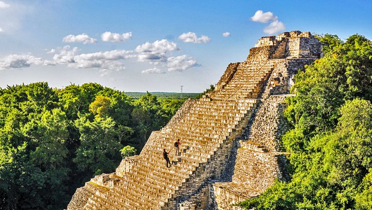 People climbing the ruins at Becan