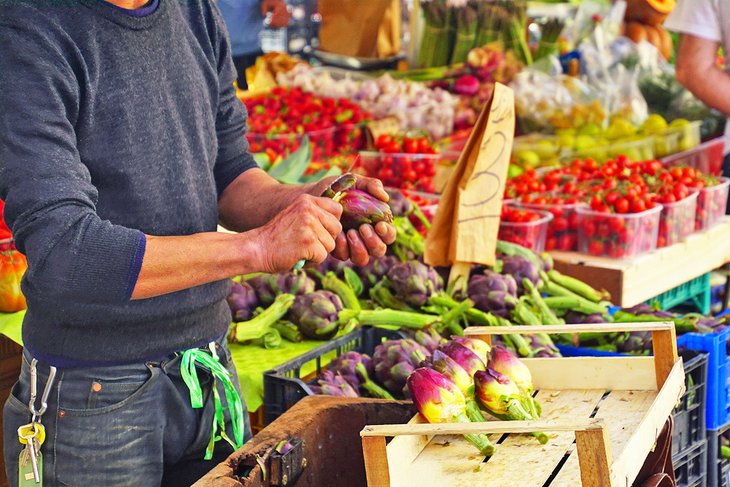 Preparing artichokes for sale in Livorno's Central Market