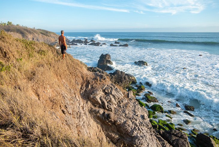 Surfer checking out the waves in Playa La Ticla