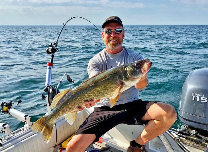 Fisherman holding a large walleye caught on Lake Erie