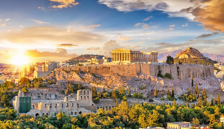 The Acropolis of Athens with the Parthenon Temple on top of the hill at sunset