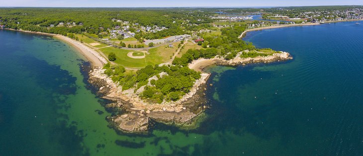 Aerial view of Stage Fort Park with Half Moon Beach on the right