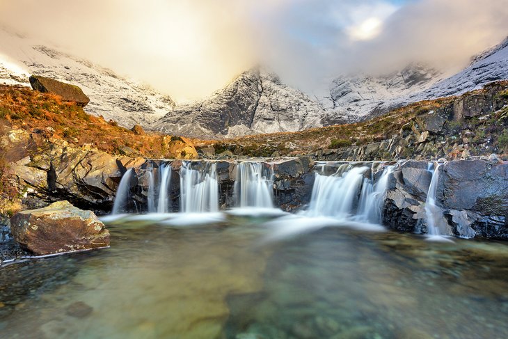 The Fairy Pools on the Isle of Skye backed by the snowcapped Black Cuillin Mountains